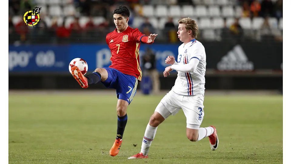 Carlos Soler disputando un balón con el jugador de Islandia